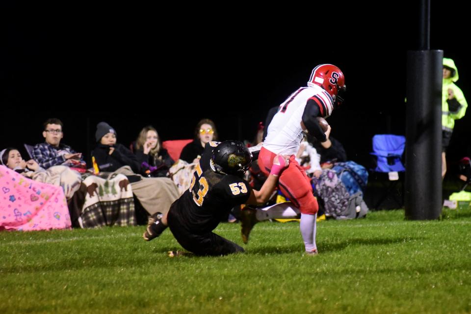 Parker Ketterman, a junior, tackles a Cardinal Stritch player in the end zone for a safety during Colonel Crawford's home 50-0 win Saturday.