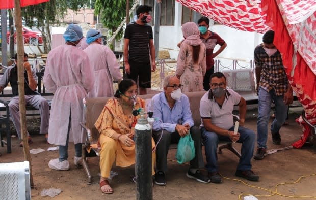 COVID-19 patients receive oxygen outside a government run hospital in Jammu, India, Wednesday, May 12, 2021. (Channi Anand/Associated Press - image credit)