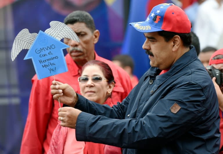 Venezuelan president Nicolas Maduro greets supporters during a march to mark International Workers' Day, in Caracas on May 1, 2016