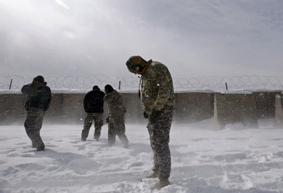 <p>U.S. soldiers turn away as a U.S. Black Hawk helicopter takes off from a U.S. base in the Jaji district of the southeastern Paktia province, near the Afghan-Pakistan border Jan. 27, 2008. (Photo: Ahmad Masood/Reuters) </p>