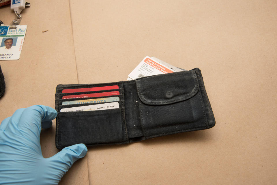 An investigator holds the wallet of Philando Castile.&nbsp;