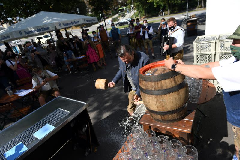 Manager of beer garden taps first barrel near Theresienwiese where Oktoberfest would have started in Munich