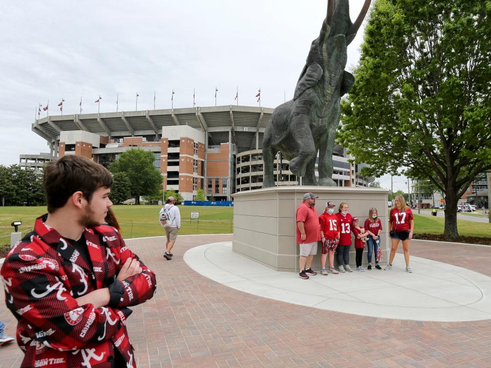 Apr 17, 2021; Tuscaloosa, Alabama, USA;  Ashton Jacques wears his Alabama sport coat as he waits to have his photo taken with "Tuska", a life-sized elephant statue newly placed at Bryant-Denny Stadium. Mandatory Credit: Gary Cosby-USA TODAY Sports