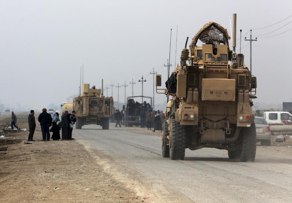 U.S. Army armoured vehicles travel in Bartella, around 19 miles (30 kilometers), from Mosul, Iraq, Saturday, Dec 31, 2016. (AP Photo/ Khalid Mohammed)