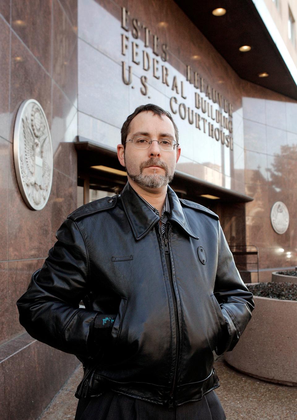 File: Alex Friedmann stands outside the Federal Courthouse in Nashville, Tenn., Feb. 19, 2008. Tennessee prison officials on Wednesday, Dec. 15, 2021, agreed to ease restrictions on Friedmann, who is being held pre-trial at a maximum security prison in Nashville. Friedman was arrested last year and accused of hiding loaded guns and ammunition in a jail under construction in Nashville. (AP Photo/Mark Humphrey, File)