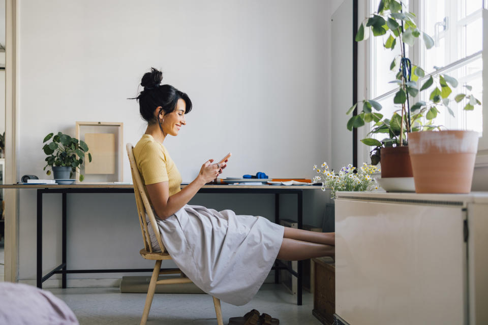 Woman puts up her feet in her apartment