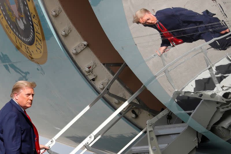 President Trump is seen reflected while boarding Air Force One in West Palm Beach