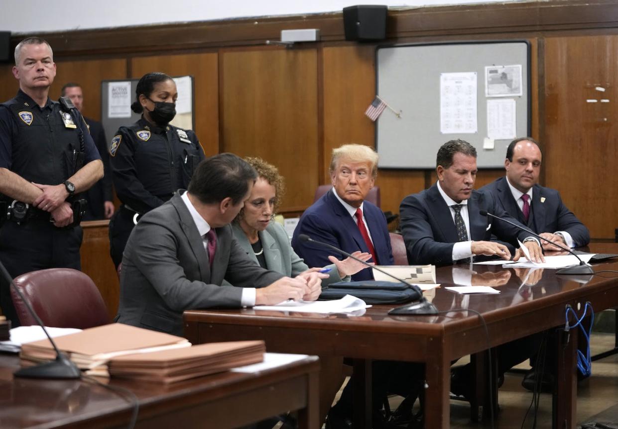 Former U.S. President Donald Trump sits with his attorneys for his arraignment at the Manhattan criminal court on April 4, 2023, in New York City. <a href="https://www.gettyimages.com/detail/news-photo/former-u-s-president-donald-trump-sits-with-his-attorneys-news-photo/1479825853?adppopup=true" rel="nofollow noopener" target="_blank" data-ylk="slk:Pool/ Getty Images News via Getty Images North America;elm:context_link;itc:0;sec:content-canvas" class="link "> Pool/ Getty Images News via Getty Images North America</a>