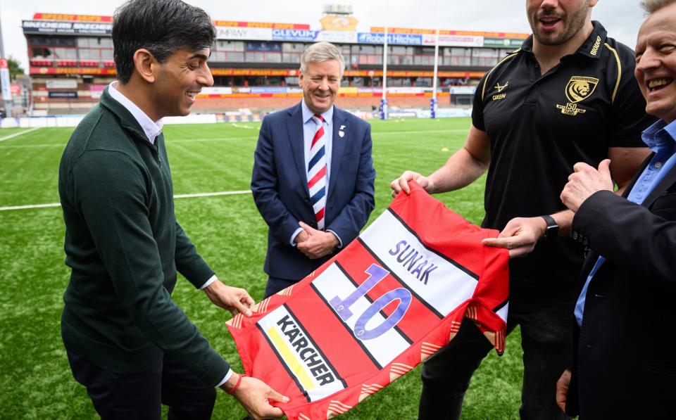 Rishi Sunak is presented with a Gloucester Rugby jersey during a visit to Gloucester Rugby Club today