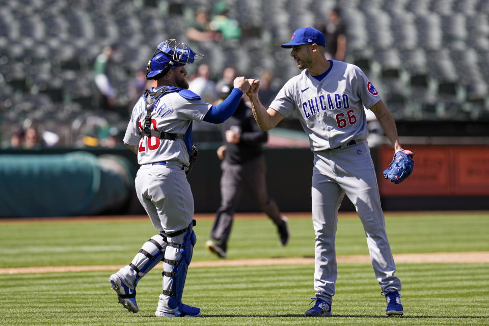 Chicago Cubs catcher Tucker Barnhart, left, and pitcher Julian Merryweather celebrate the team's 12-2 victory over the Oakland Athletics in a baseball game in Oakland, Calif., Wednesday, April 19, 2023. (AP Photo/Godofredo A. Vásquez)