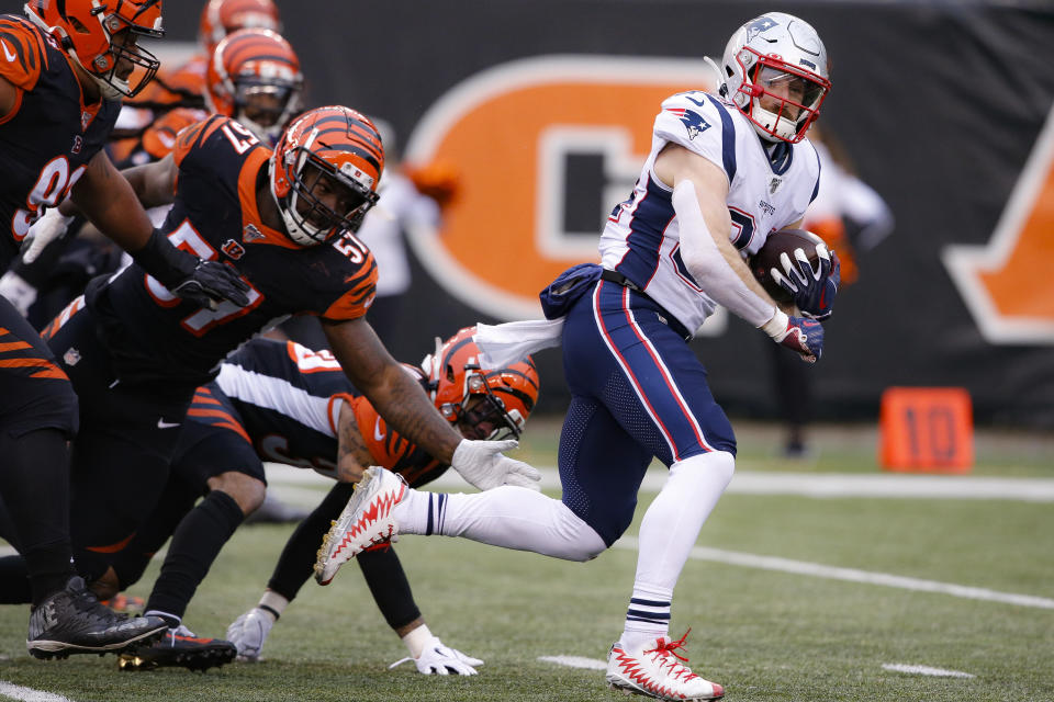 New England Patriots running back Rex Burkhead (34) breaks away from Cincinnati Bengals linebacker Germaine Pratt (57) and runs in for a touchdown in the second half of an NFL football game, Sunday, Dec. 15, 2019, in Cincinnati. (AP Photo/Gary Landers)