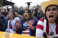 Fans of the United States soccer team, from right,Patricio Pichling, Eesha Pendharkar and Dania Abdalla react as they watch on television at a bar in Washington the United States team play against the Netherlands during their World Cup soccer match, Saturday, Dec. 3, 2022. (AP Photo/Manuel Balce Ceneta)