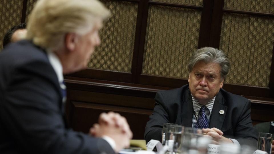 White House Chief Strategist Steve Bannon listens at right as President Donald Trump speaks during a meeting on cyber security in the Roosevelt Room of the White House in Washington, Tuesday, Jan. 31, 2017.