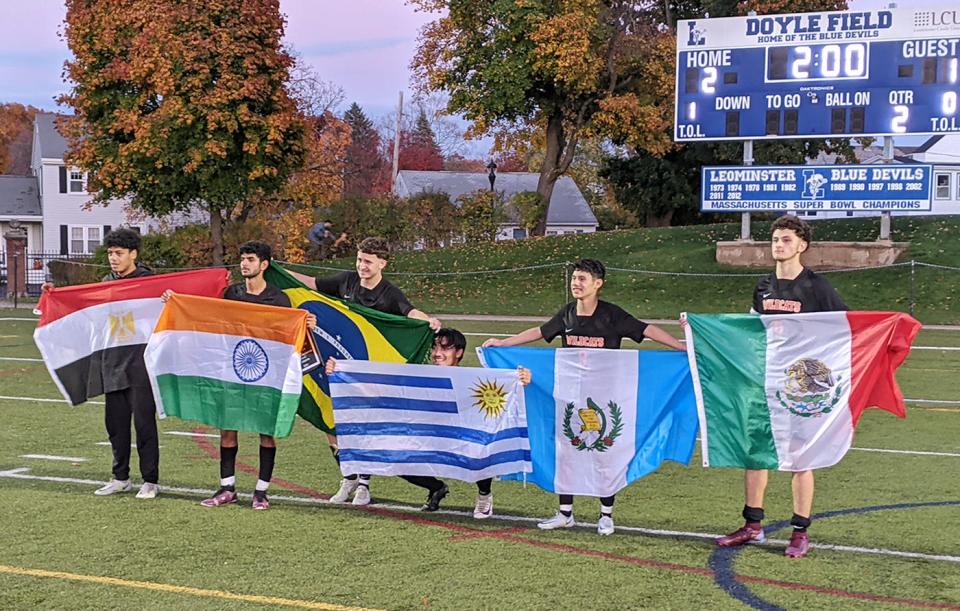 Members of the Gardner High boys soccer team celebrated with the flags of their native countries after the Wildcats won the CMADA Class C title, 2-1, over Maynard on Tuesday, Nov. 1 at Doyle Field in Leominster. From left to right, Kerolos Soliman (Egypt), Dhruv Patel (India), Fabio Carvalho (Brazil), Elvis Camejo (Uruguay), Henry Aguilar (Guatemala), and Ricky Ruiz (Mexico).