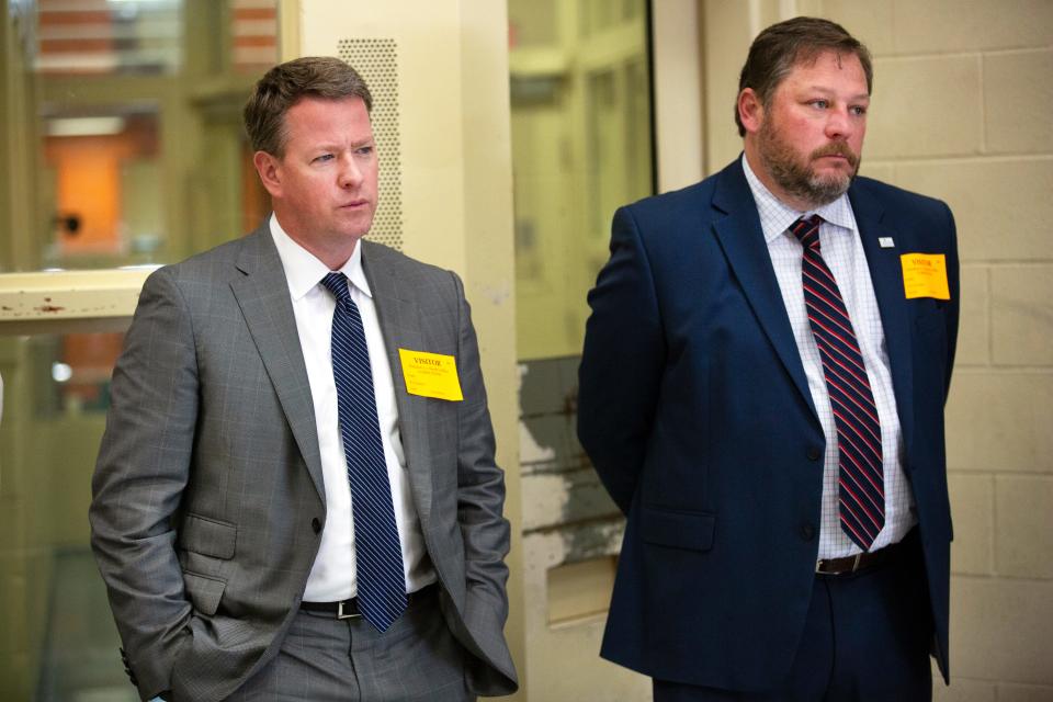 Brad McLane, chief administrator of NaphCare health services, and Josh Arnold, vice president of Talbert House, listen to women in the recovery pod in the Hamilton County Justice Center.