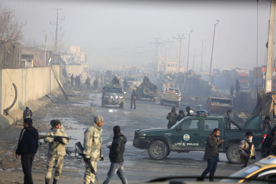 Afghan security forces gather at the site a day after an attack in Kabul, Afghanistan, Tuesday, Jan. 15, 2019. A Taliban suicide bomber detonated an explosive-laden vehicle in the capital Kabul on Monday evening, according to officials. (AP Photo/Rahmat Gul)