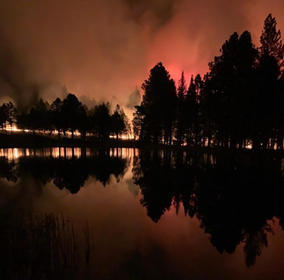 The Hermits Peak-Calf Canyon fire burns on a recent night. The fire is now the biggest in New Mexico's history.