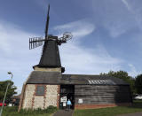 A woman arrived at a polling station located in West Blatchington Windmill near Hove, south east England, Thursday May 23, 2019, as polls opened in elections for the European Parliament. (Steve Parsons/PA via AP)