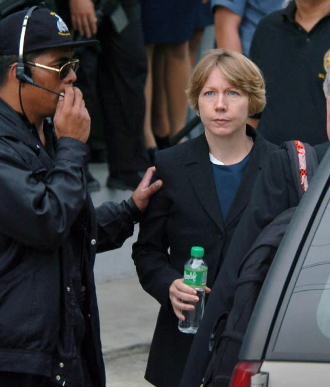 Former Abu Sayyaf hostage, US missionary Gracia Burnham (R) escorted by Filipino agent of the National Bureau of Investigation (NBI) leaves the court after testifying at trial of jailed members of the Abu Sayyaf in suburban Bicutan 29 July 2004