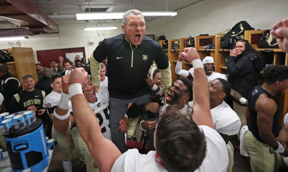 Army coach Jeff Monken is hoisted as he speaks to his team in the locker room following a 44-7 win against at Massachusetts. DANNY WILD/USA TODAY Sports