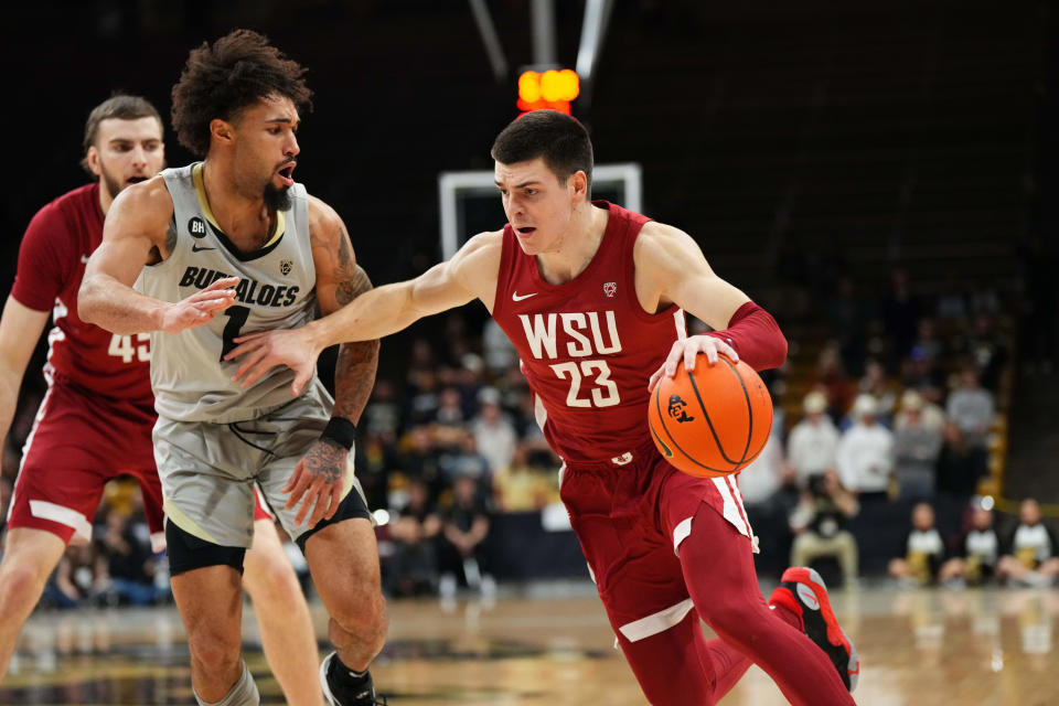 Washington State Cougars forward Andrej Jakimovski (23) drives at Colorado Buffaloes guard J'Vonne Hadley (1) in the first half at the CU Events Center on Dec. 31 in Boulder.