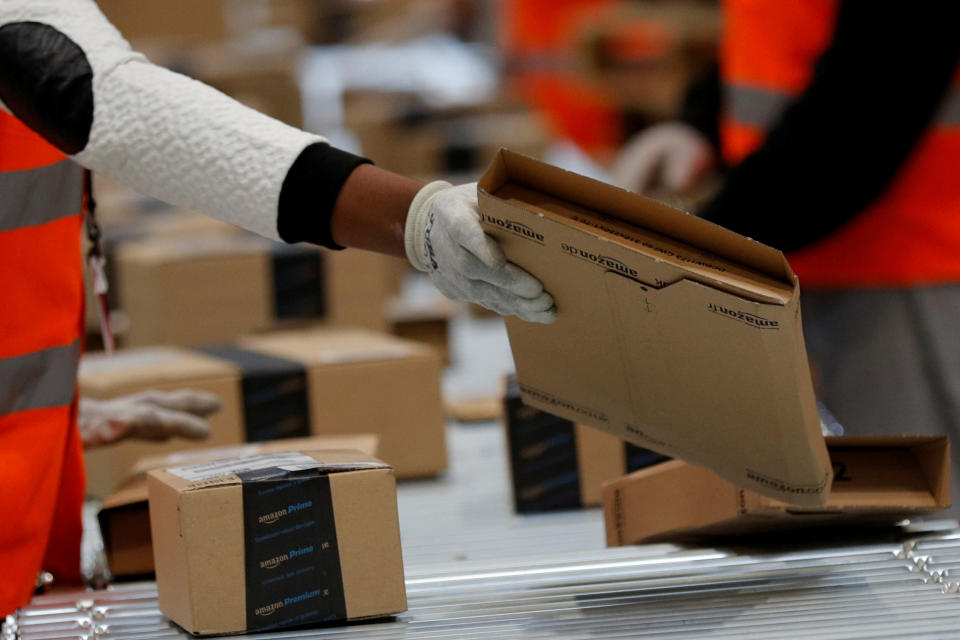 Employees sort packages at the Amazon distribution center warehouse in Saran, near Orleans, France. REUTERS/Philippe Wojazer