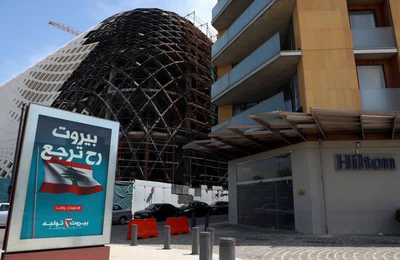 An electoral campaign billboard is pictured near a closed Hilton hotel in Beirut