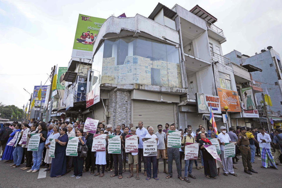 Sri Lankan Catholics hold banner during a silent protest march to mark the fourth year commemoration of the 2019, Easter Sunday bomb attacks on Catholic Churches, in Colombo, Sri Lanka, Friday, April 21, 2023. Thousands of Sri Lankans held a protest in the capital on Friday, demanding justice for the victims of the 2019 Easter Sunday bomb attacks that killed nearly 270 people. (AP Photo/Eranga Jayawardena)