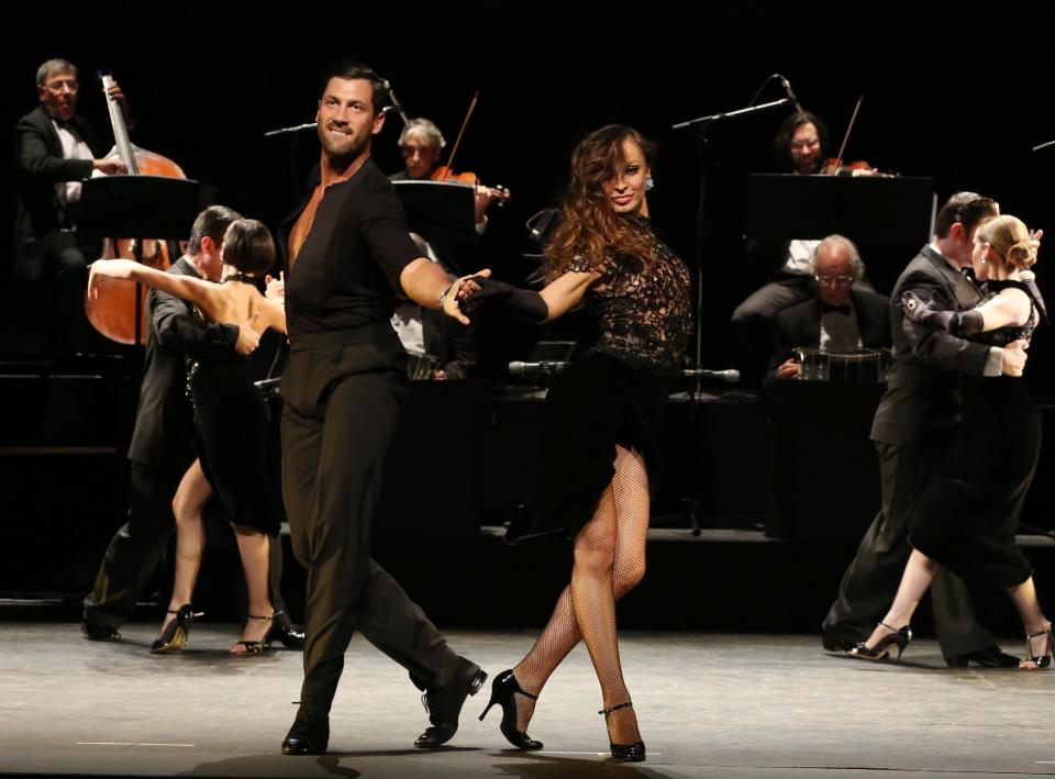 In this July 11, 2013 photo released by The O + M Company, Maksim Chmerkovskiy, left, and Karina Smirnoff perform in "Forever Tango" at the Walter Kerr Theatre in New York. (AP Photo/The O + M Company, Walter McBride)