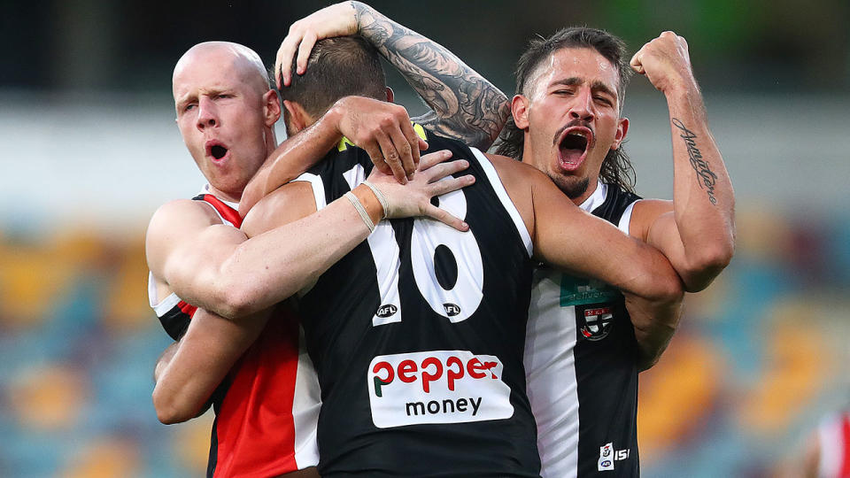 Pictured here, St Kilda players celebrate during their win over Essendon.