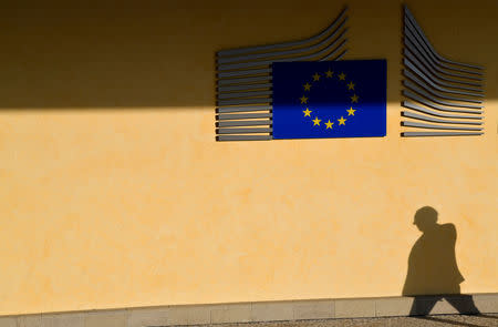 FILE PHOTO: The shadow of a worker is seen beside the EU Commission building in Brussels, Belgium, October 17, 2018. REUTERS/Toby Melville/File Photo
