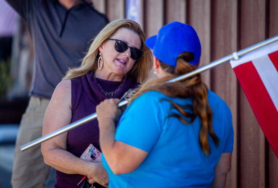 Republican state Rep. Kelly Townsend speaks with a protester after a protest against Gov. Ducey's delay to reopen some businesses on May 1, 2020, in Apache Junction.