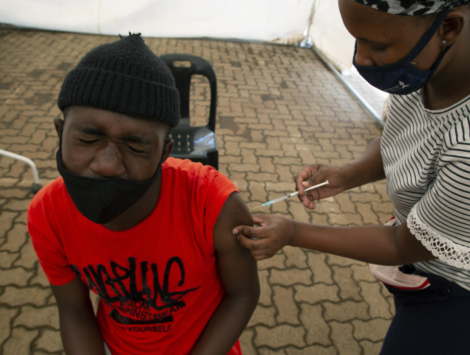A man receives a dose of a vaccine at a COVID-19 vaccine centre, in Soweto, Monday, Nov. 29, 2021. The World Health Organization has urged countries not to impose flight bans on southern African nations due to concerns over the new omicron variant. (AP Photo/Denis Farrell)