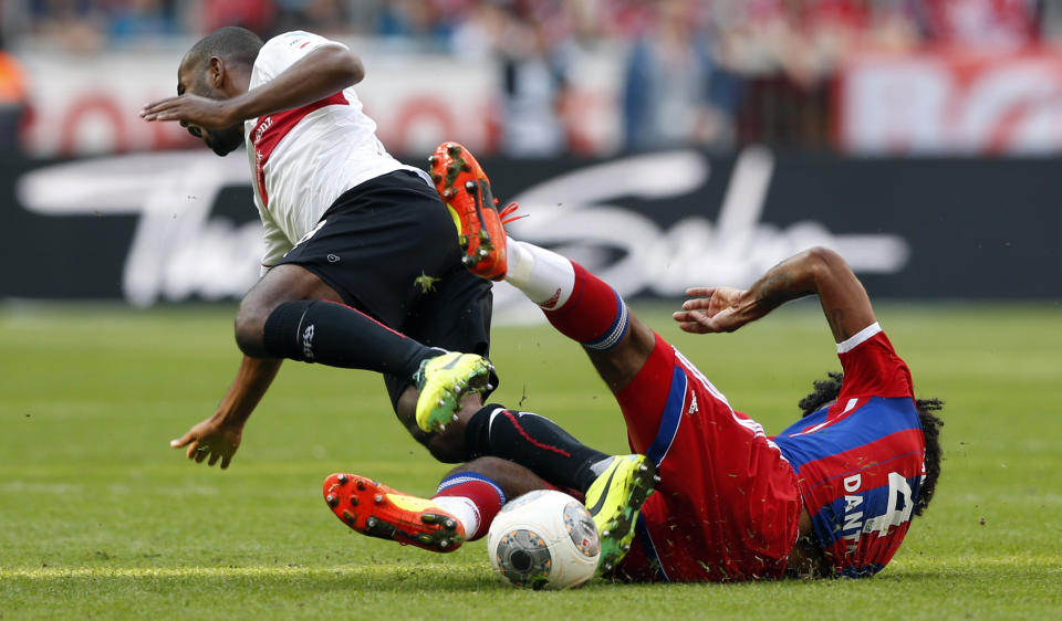 Stuttgart's Cacau, left, is fouled by Bayern's Dante of Brazil during the German first division Bundesliga soccer match between FC Bayern Munich and VfB Stuttgart, in Munich, southern Germany, Saturday, May 10, 2014. (AP Photo/Matthias Schrader)