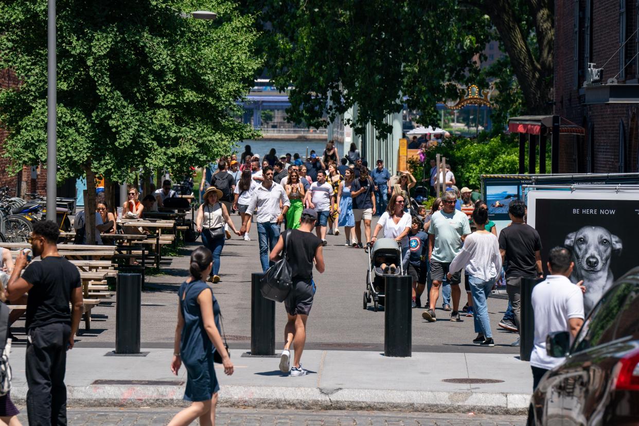 In this file photo, People are out enjoying the warmer weather at Brooklyn Bridge Park in Brooklyn on June 4, 2022.