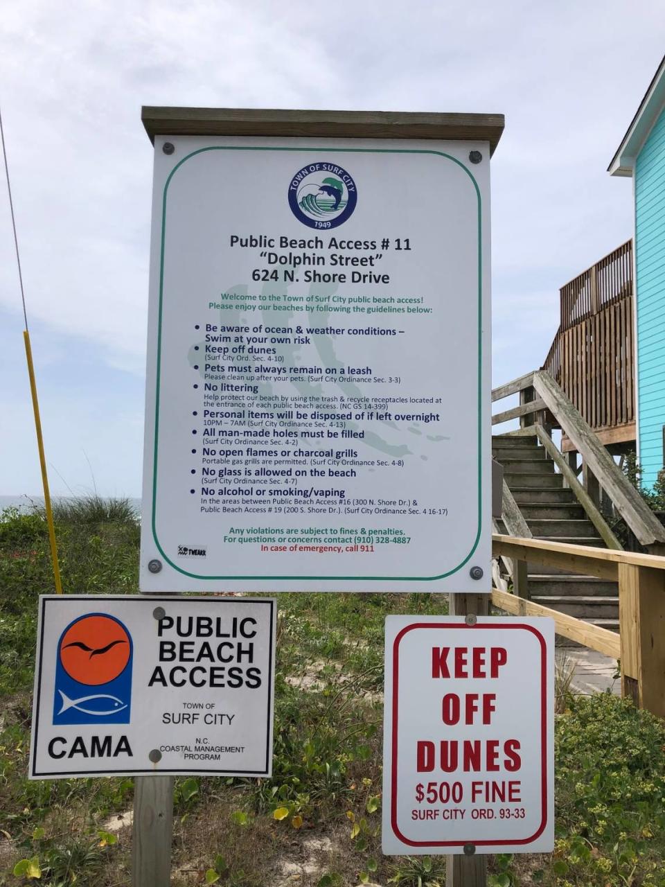 A posted sign on the beach at Surf City, NC, on May 27, 2022, notes that pets must remain on leashes and that owners must clean up after pets.