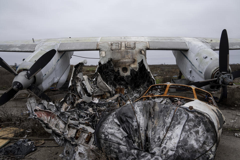 An aircraft that was destroyed during fighting between Ukrainian and Russian forces is seen at the Kherson international airport in Kherson, Ukraine, Friday, Dec. 2, 2022. (AP Photo/Evgeniy Maloletka)