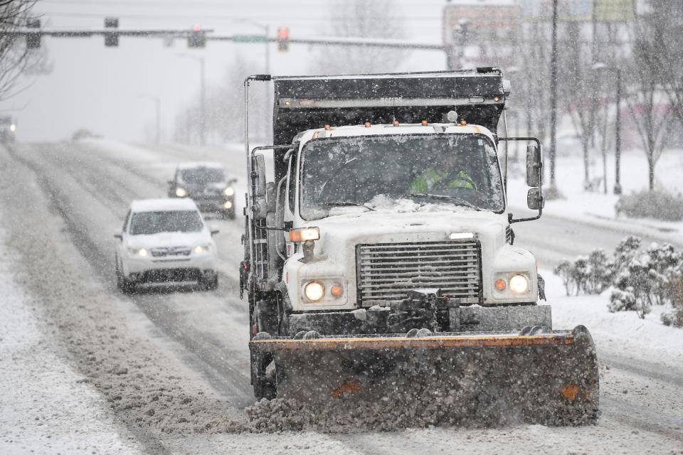 A plow truck drives down Magnolia Avenue in East Knoxville, during a snowstorm on Jan. 15.