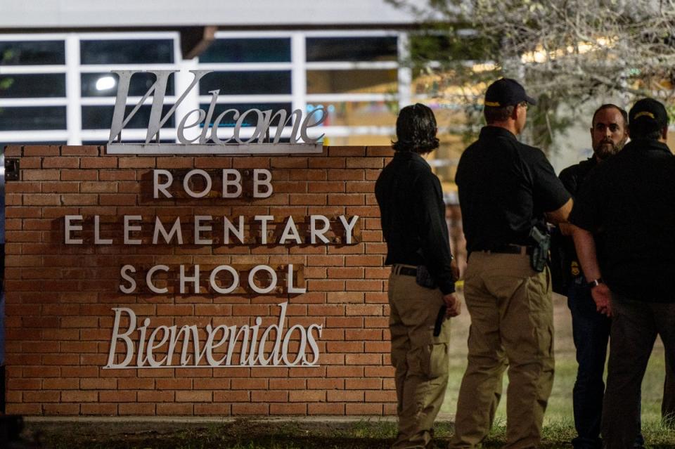 Law enforcement officers speak together outside of Robb Elementary School following the mass shooting (Getty Images)