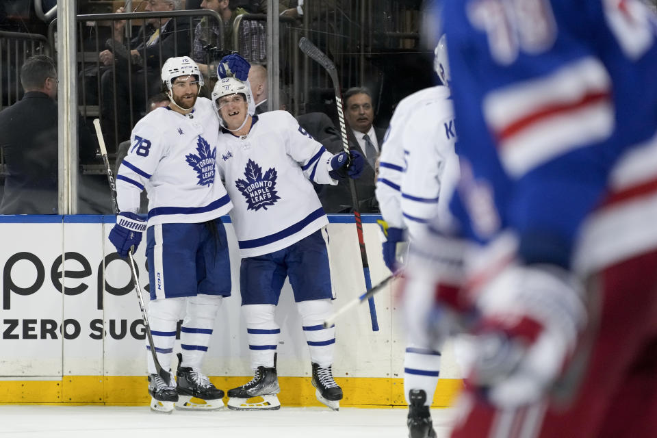 Toronto Maple Leafs center Noel Acciari, center, celebrates with defenseman TJ Brodie (78) after scoring on New York Rangers goaltender Jaroslav Halak during the third period of an NHL hockey game, Thursday, April 13, 2023, in New York. (AP Photo/John Minchillo)