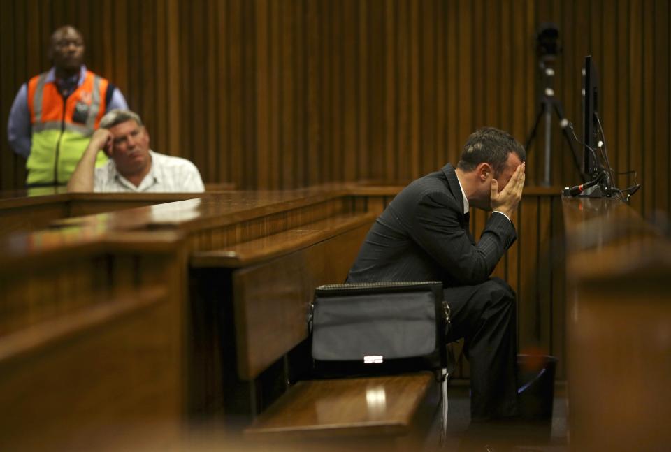 Olympic and Paralympic track star Oscar Pistorius reacts in the dock during his trial for the murder of his girlfriend Reeva Steenkamp, at the North Gauteng High Court in Pretoria March 10, 2014. Pistorius is on trial for murdering his girlfriend Reeva Steenkamp at his suburban Pretoria home on Valentine's Day last year. He says he mistook her for an intruder. REUTERS/Siphiwe Sibeko (SOUTH AFRICA - Tags: CRIME LAW SPORT ATHLETICS)