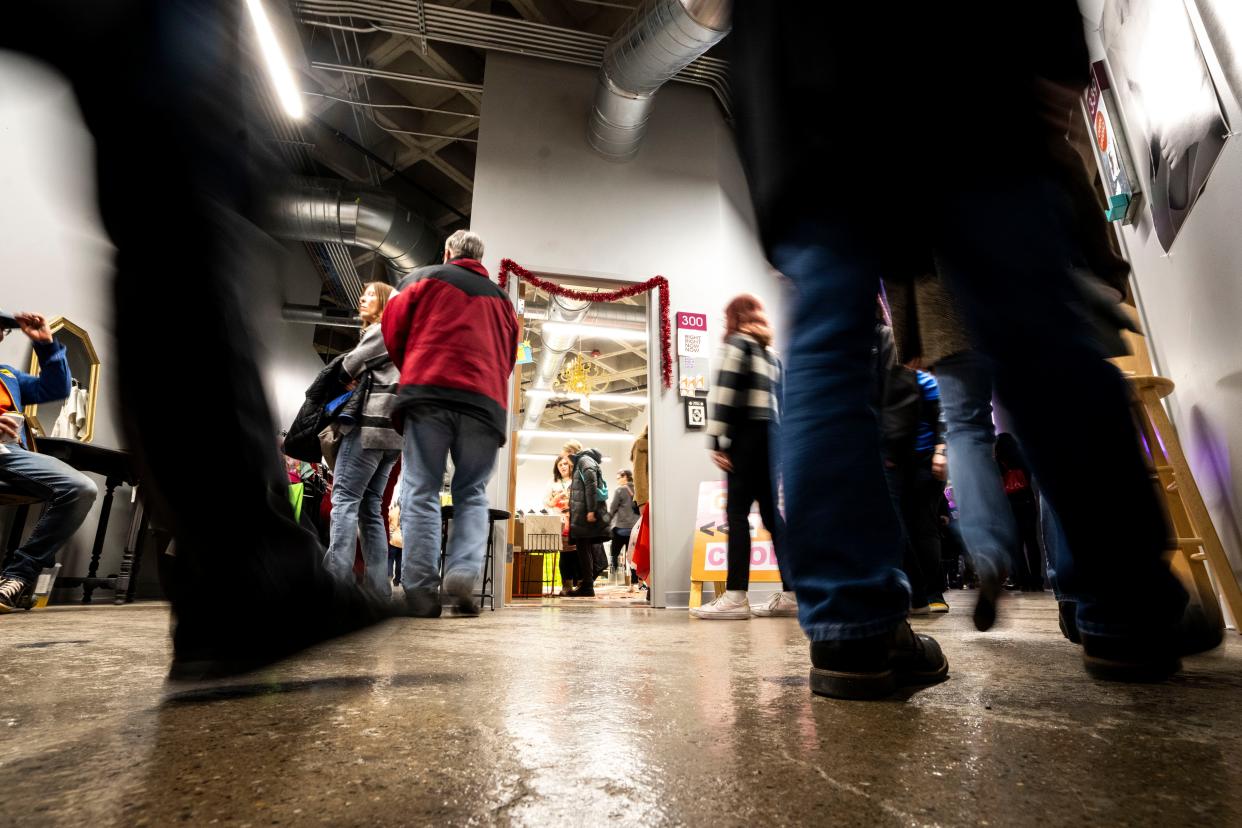 People walk past open studios during First Friday at Mainframe Studios on Friday, December 1, 2023 in Des Moines.