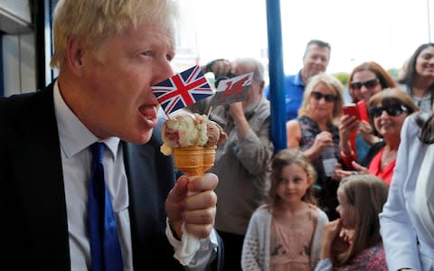 Conservative Party leadership candidate Boris Johnson eats an ice cream as he visits Barry Island in Wales - Credit: Getty&nbsp;