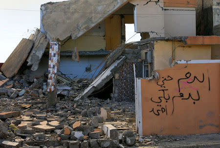 A text on a wall reads that the house belongs to Islamic State militants in Qayyara, Iraq, December 6, 2016. Picture taken December 6, 2016. REUTERS/Alaa Al-Marjani