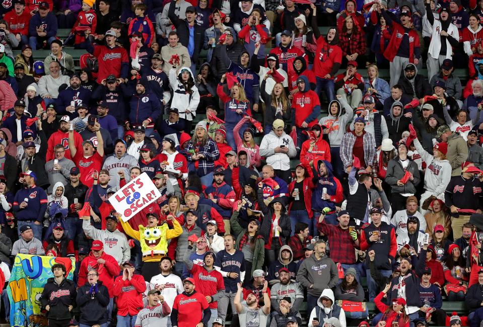 Cleveland Guardians fans, including one dressed as SpongeBob cheer for Cleveland Guardians right fielder Oscar Gonzalez (39) during the second inning of Game 4 of an American League Division baseball series at Progressive Field, Sunday, Oct. 16, 2022, in Cleveland, Ohio.
