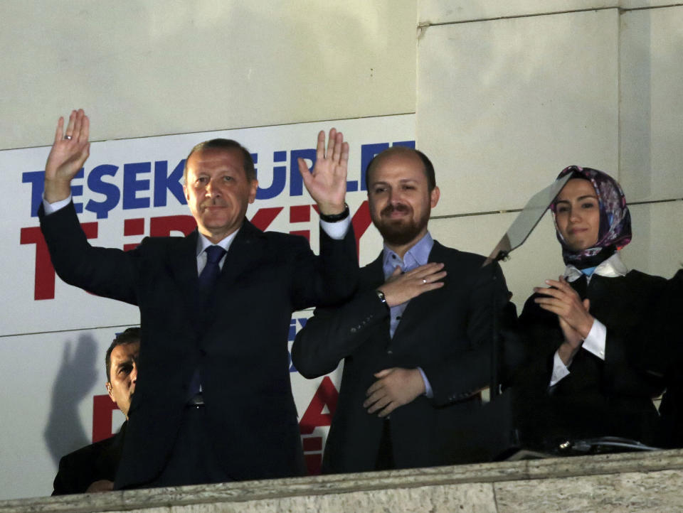 Turkey's Prime Minister Recep Tayyip Erdogan, his son Bilal Erdogan and daughter Sumeyye Erdogan salute supporters from the balcony of his ruling party headquarters in Ankara, Turkey, early Monday, March 31, 2014. Erdogan on Sunday hailed what appeared to be a clear victory for his party in local elections, providing a boost that could help him emerge from a spate of recent troubles. Erdogan was not on the ballot in the countrywide polls, but with about half of the votes counted, Turkish newswires suggested that his party was significantly outstripping its results in the last local elections in 2009 and roundly beating the main opposition party. (AP Photo)