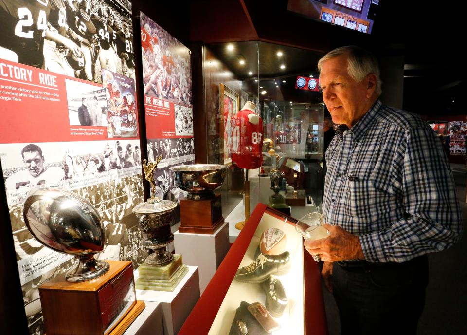 Lee Roy Jordan, former University of Alabama and Dallas Cowboys linebacker, looks over a display from one of the teams he played for under Paul W. "Bear" Bryant during a 2018 visit to the Paul W. Bryant Museum.