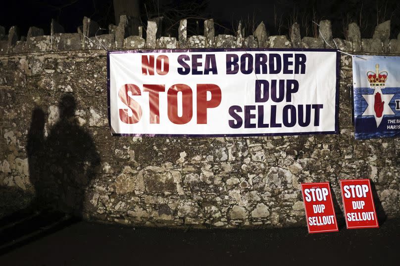 A shadow of Loyalist protesters is seen on the wall outside the grounds were the Democratic Unionist Party executive meeting is taking place at Larchfield Estate in Lisburn.