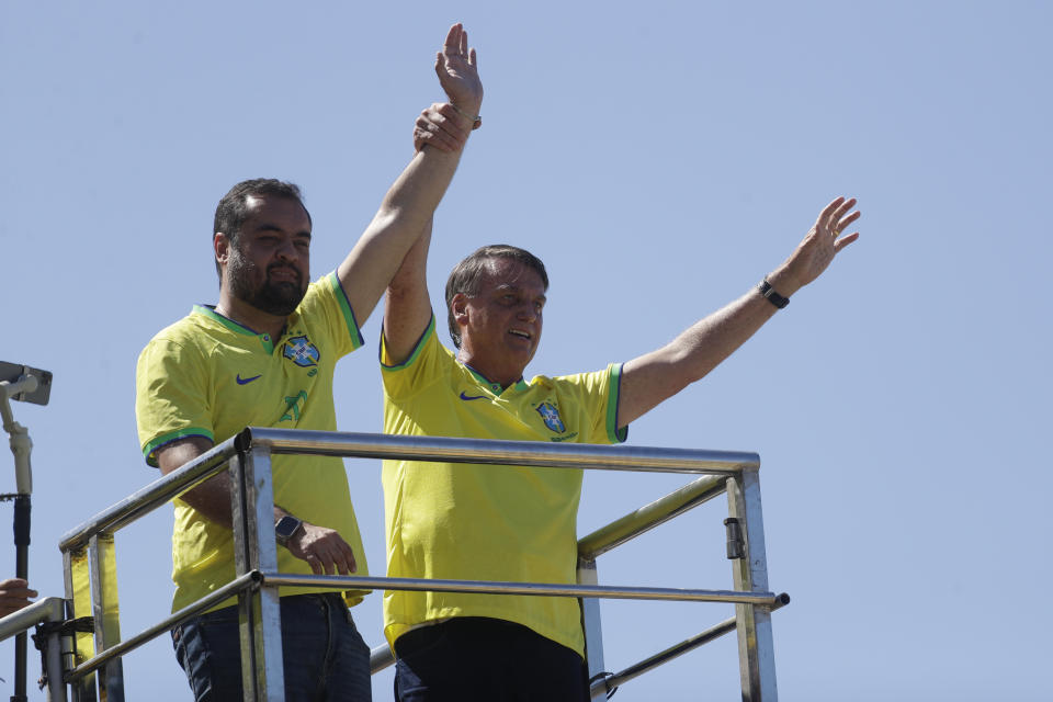 Brazil's former President Jair Bolsonaro, right, and Rio de Janeiro State Governor Claudio Castro greet supporters during a demonstration calling for freedom of expression, spurred by Brazilian court orders to suspend accounts on the social media platform X, in Copacabana beach, Rio de Janeiro, Brazil, Sunday, April 21, 2024. (AP Photo/Bruna Prado)