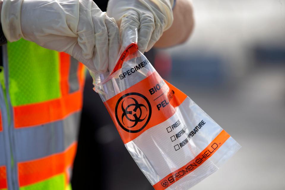 A testing kit is prepared to get a sample from a patient to test for COVID-19 at a federal surge testing site at Maryvale High School in Phoenix, on July 17, 2020. The surge testing site which is free will continue at Maryvale High School for 12 days.